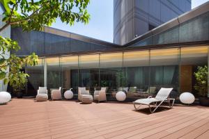 a building with a row of chairs on a patio at Cerulean Tower Tokyu Hotel, A Pan Pacific Partner Hotel in Tokyo