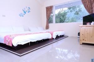 Postel nebo postele na pokoji v ubytování Zuo An Hostel