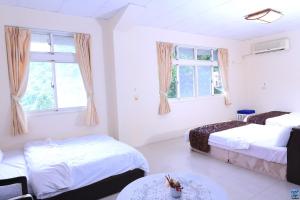 Postel nebo postele na pokoji v ubytování Zuo An Hostel