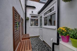 a porch with a wooden door and some plants at 38 George Street in Whitby