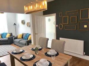 a living room with a wooden table and chairs at 38 George Street in Whitby