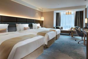 Letto o letti in una camera di Caesar Park Hotel Banqiao