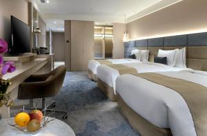Letto o letti in una camera di Caesar Park Hotel Banqiao