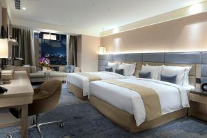 Letto o letti in una camera di Caesar Park Hotel Banqiao