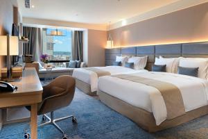 Letto o letti in una camera di Caesar Park Hotel Banqiao