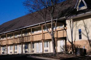 a large white building with trees in front of it at Brookwood Inn Branson in Branson