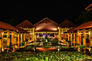 a building with a fountain in front of it at night at Pandanus Resort in Mui Ne