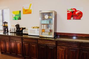 a kitchen counter with an open refrigerator on it at Americas Best Value Inn-Fredonia in Fredonia