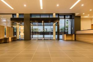 an empty lobby of a building with glass doors at Karaksa Hotel Osaka Namba in Osaka
