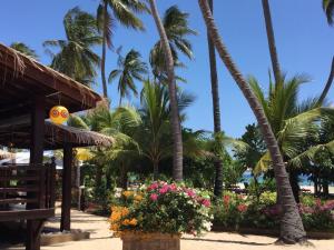 a resort with palm trees and flowers on the beach at Nilaveli Beach Resort - Level 1 Certified in Nilaveli