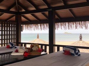 a room with two beds and a view of the beach at Nilaveli Beach Resort - Level 1 Certified in Nilaveli