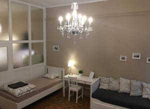 a living room with a chandelier and a desk at Julija & Filip Apartments in Ljubljana