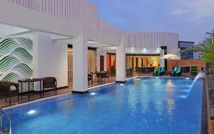 a pool in a hotel with chairs and tables at Fortune Park BBD, Lucknow - Member ITC Hotels' Group in Lucknow