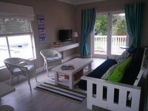 a living room with a couch and a table at Island Nest in Knysna