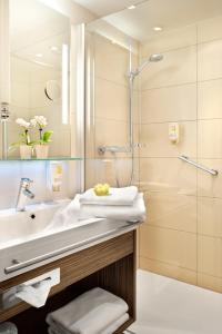 a bathroom with a sink and a shower at Best Western Hotel Favorit in Ludwigsburg