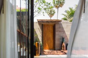 a door in a building with a window at Saai Resort in Bang Saphan Noi