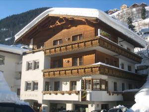 a large building with snow on top of it at Ad-Capellam in Kappl