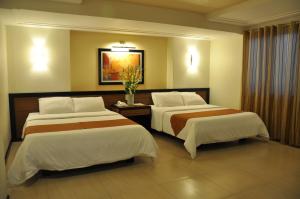 Tempat tidur dalam kamar di O Hotel