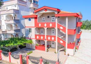 a building with red and white paint on it at Friendly House in Ulcinj