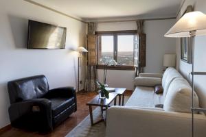 a living room with a couch and two chairs at Parador de Toledo in Toledo