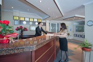 un homme et une femme debout à un comptoir dans un salon dans l'établissement Regina Hotel, à Sunny Beach 31 autres photos