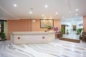 a lobby with a reception desk in a building at Hotel Niladri in Puri