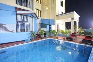 a swimming pool on the side of a building at Hotel Niladri in Puri