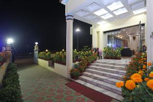 a building with a bunch of flowers and stairs at Hotel Niladri in Puri