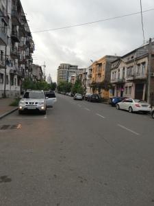 a street with cars parked on the side of the road at Mamuka House in Batumi