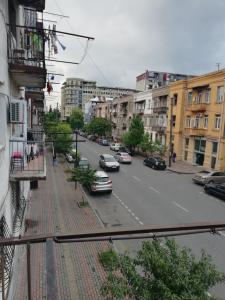 a city street with cars parked on the road at Mamuka House in Batumi
