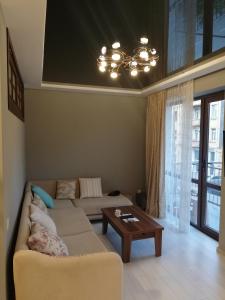 a living room with a couch and a table at Mamuka House in Batumi