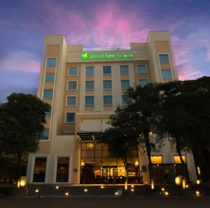 a hotel with a lit up sign on top of it at Lemon Tree Premier City Center in Gurgaon