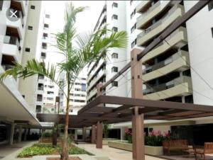 una palmera frente a un edificio en Apartamento na Ponta Verde, en Maceió