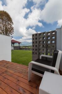 a patio with a bench on a wooden deck at FomeStay in Chishang