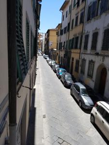 a street with cars parked on the side of a building at Gino's place in Florence