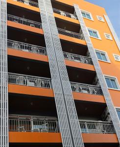 an orange and black building with a ladder at Patong Mansion - SHA Certified in Patong Beach