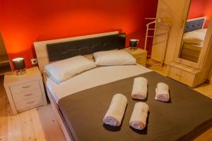 a bedroom with a large bed with slippers on it at Manto's House Lefkada in Évyiros