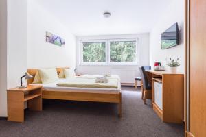 Postel nebo postele na pokoji v ubytování Hotel&Wellness Knížecí rybník