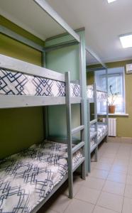 two bunk beds in a room with a window at Ilyinskiy Hostel in Nizhny Novgorod