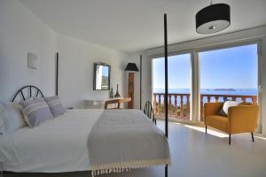 a bedroom with a bed and a view of the ocean at C'an Petra, Carrer Club Robinson in San Jose