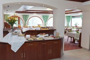 a kitchen with a table with food on it at Hotel Mozart in Landeck