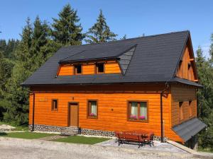 a large wooden house with a black roof at Penzion Relax in Nižná