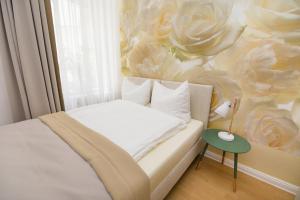 a bedroom with a bed with a flower mural at Hotel Reverey * kontaktloser Self Check-In * in Hannover
