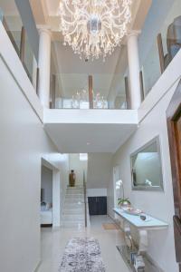 a large white hallway with a chandelier at JoJo's BnB in Mossel Bay