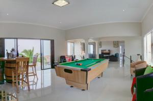 a living room with a pool table in it at JoJo's BnB in Mossel Bay