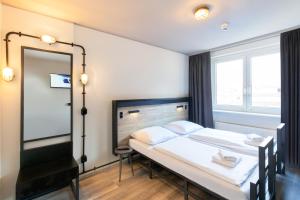 Postel nebo postele na pokoji v ubytování a&o Berlin Mitte