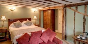 a bedroom with a large bed and a couch at Brigands Inn in Mallwyd