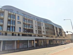 a large building on the corner of a street at Apartament B&F Garbary Poznań Business & Family - Parking in Poznań