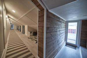 a hallway of a house with wooden walls and a window at B&B Villa Kauppila in Ii