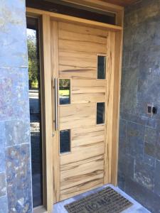 a wooden garage door with a stone wall at DreamWoods in Puerto Varas